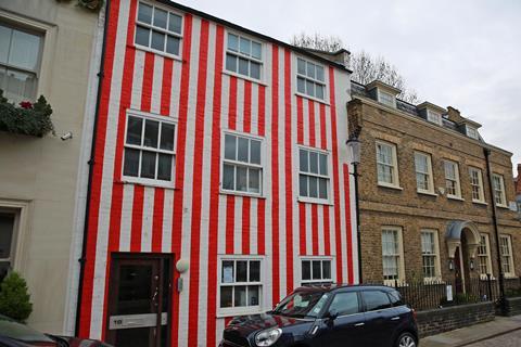 Multi-million-pound townhouse in Kensington painted with red and white vertical stripes