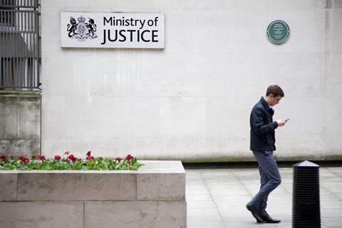 A man walks past the Ministry of Justice building, London