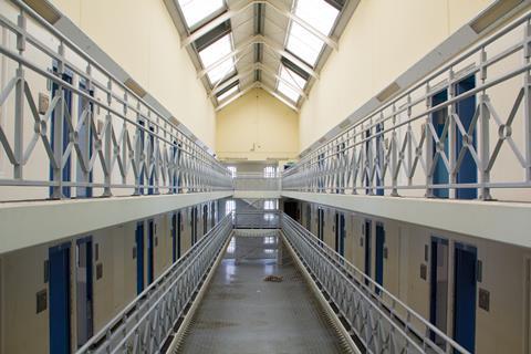 The corridors of a prison showing cell doors
