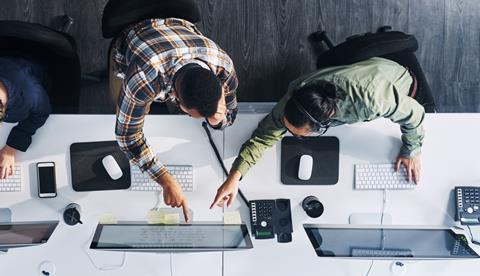 Two colleagues work together in the office