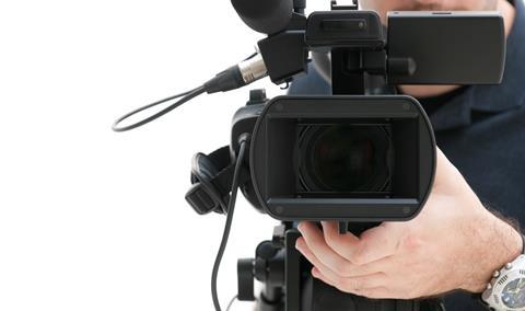 Camera man with recording equipment