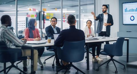 A group of young colleagues in a meeting discussion at the office