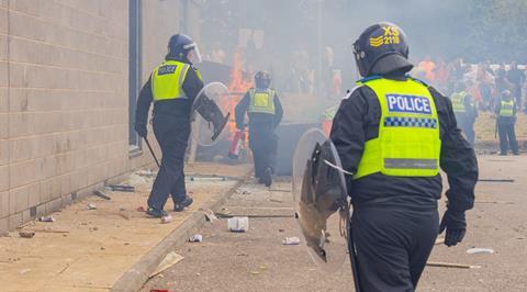 Police respond as rioters start a fire in Rotherham