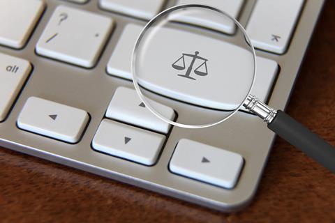 Justice scales on computer keyboard