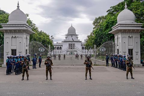 Police stand guard after Bangladesh’s top court scaled back a controversial quota system for government job applicants