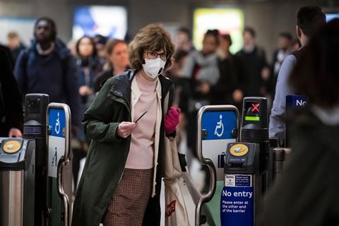Woman wearing a medical mask travelling through underground station