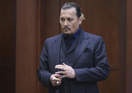 Actor Johnny Depp stands in the courtroom at the Fairfax County Circuit Court