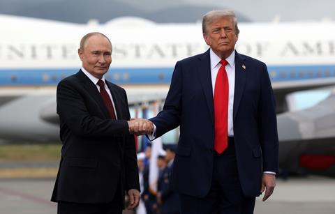 Russian President Vladimir Putin and US President Donald Trump shake hands in Alaska