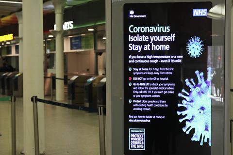 A coronavirus information sign at King's Cross railway station