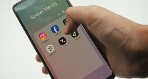 Social media app icons displayed on a phone