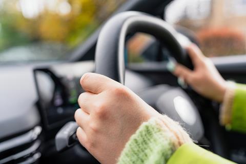 Close up shot of an anonymous driver at the wheel