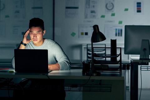 A man works on a laptop in the office