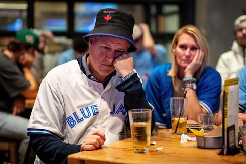 A Toronto Blue Jays fan reacts in a bar after the LA Dodgers defeated the Blue Jays in Game 7 of baseball's World Series. Vancouver, British Columbia, 1 November 2025