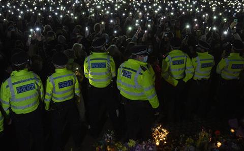 People attend a vigil for Sarah Everard by a band stand in Clapham Common, London