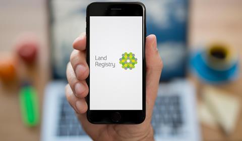The Land Registry logo is displayed on a phone