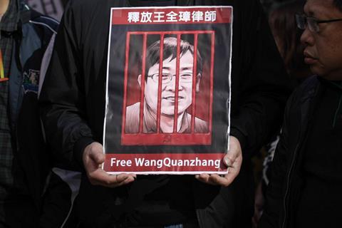 Protester seen holding a poster of Wang Quanzhang during the demonstration