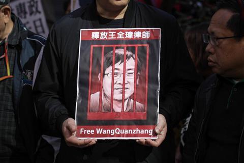 Protester seen holding a poster of Wang Quanzhang during the demonstration