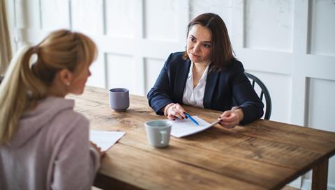 A solicitor talks through a document with her young client