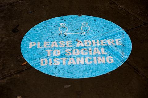 Coronavirus social distancing sign on ground