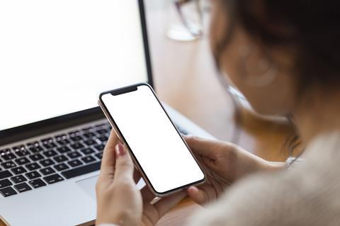 Woman on laptop and phone