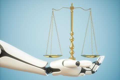 Robotic hand holds justice scales