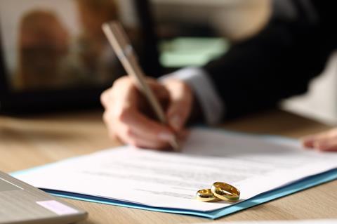 A woman signs divorce papers