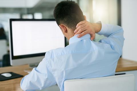 Man sat at desk/computer with neck pain