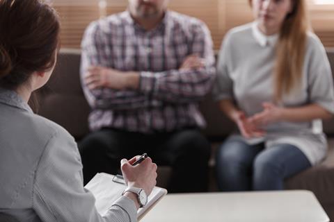 An anonymous couple sit with their lawyer