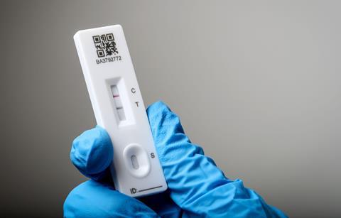 A lateral flow test showing a positive Covid result