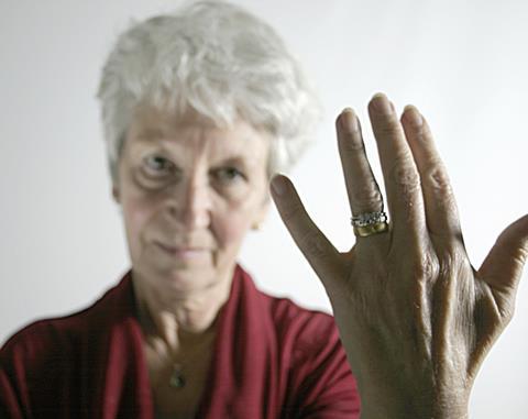 Older woman showing wedding ring