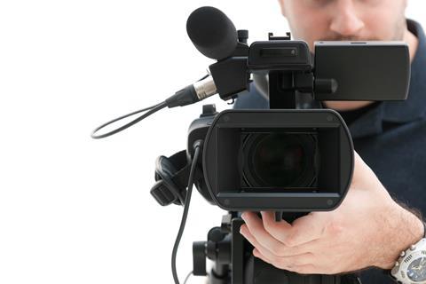 Camera man with recording equipment