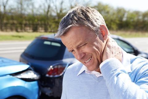 Man holds neck in pain