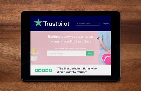 A tablet screen shows the Trustpilot homepage