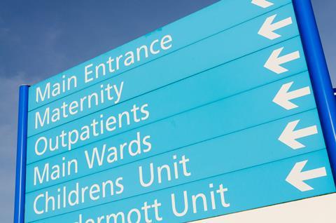A hospital sign directing to wards