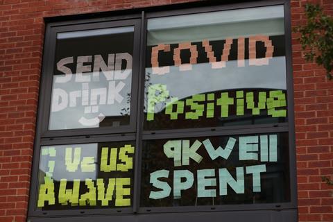 Signs on a window at Manchester Metropolitan University's Birley campus