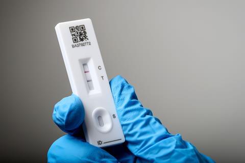 A lateral flow test showing a positive Covid result