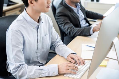 Young man working at desk in office