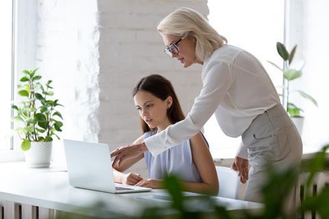 Two women work together in an office