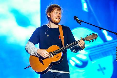 Ed Sheeran performing on stage