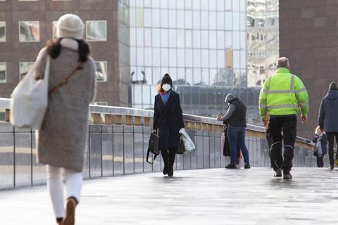 Commuters cross London Bridge during coronavirus pandemic