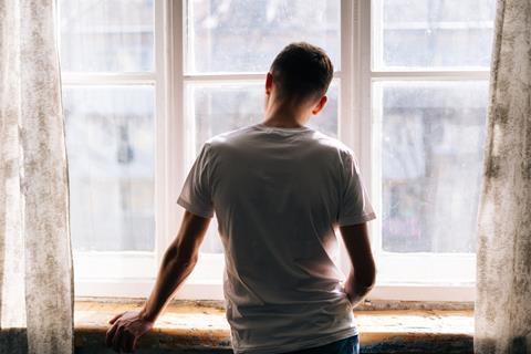 Man looking out of window