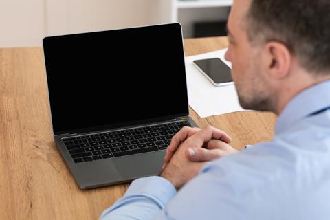 Business man waiting for video call on laptop