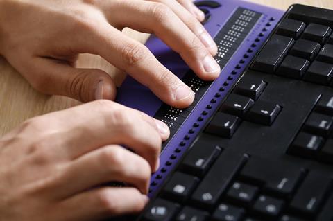 A blind person using a computer with braille computer display. The Legally Disabled? report increased law firms’ focus on disability inclusion