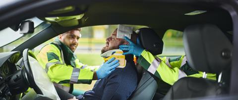 Paramedics treat a driver after a crash