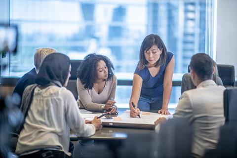 Colleagues share ideas in a meeting