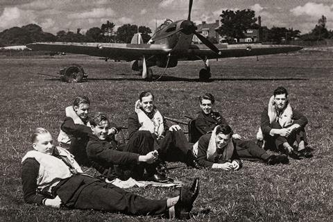 Pilots relax in front of a Hawker Hurricane single-seat fighter aircraft