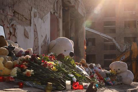 Flowers and toys mark a Kyiv residential building that was destroyed by a Russian attack on 25 April, killing 12 people