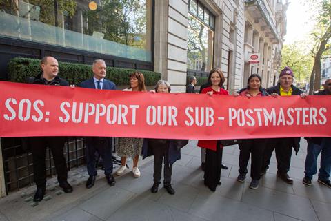 Victims of the Post Office scandal hold a banner outside the inquiry